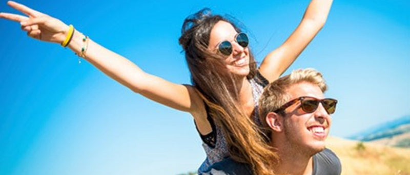 man giving woman piggy back ride