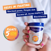 Hand holding Clearasil pads with benefits: fights blocked pores, excess oil, acne marks, blackheads