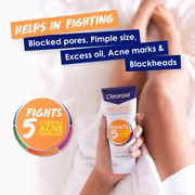 Person holding Clearasil face wash tube – fights 5 signs of acne problems