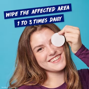 Smiling woman using Clearasil pad with instruction: wipe affected area 1 to 3 times daily